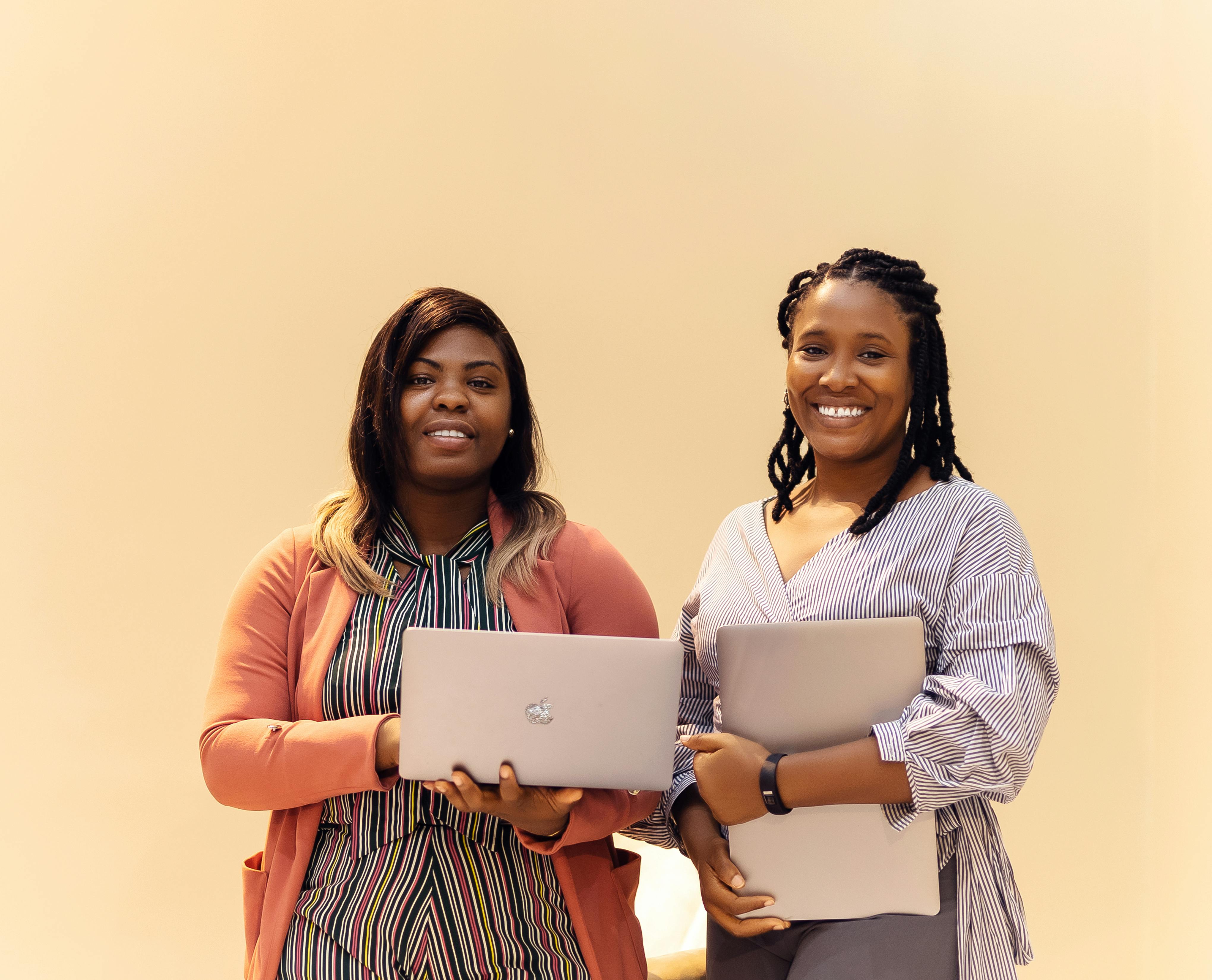 Business team collaborating on laptops